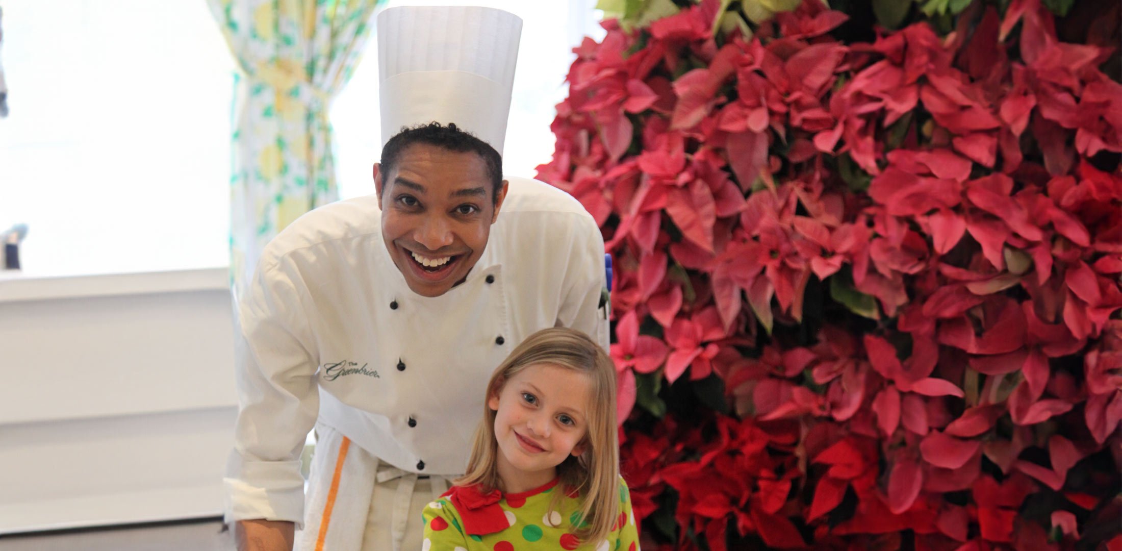 A chef and a child smiling